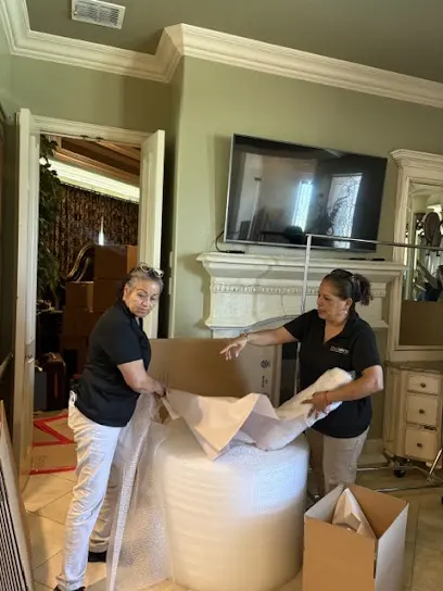 An Arlington Water Damage Pros crew protecting contents in a water damaged Arlington, TX home