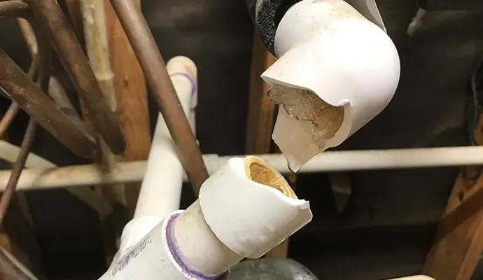 A frozen pipe that split during a hard freeze in an Arlington, TX home