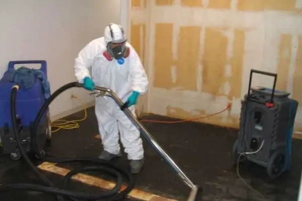 Category 3 black water cleanup crew in protective gear in an Arlington, TX home