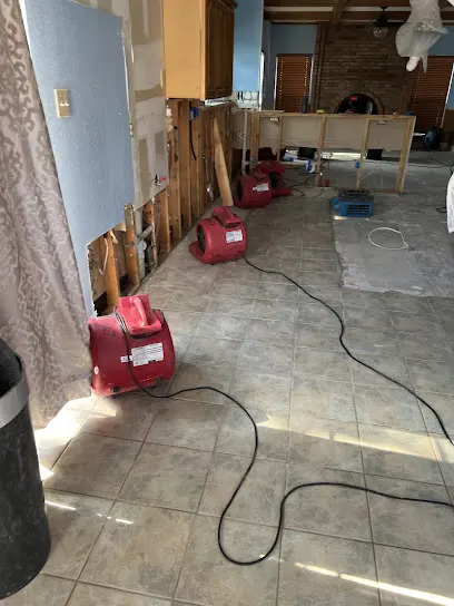 Air movers and a dehumidifier drying a room in an Arlington, TX home
